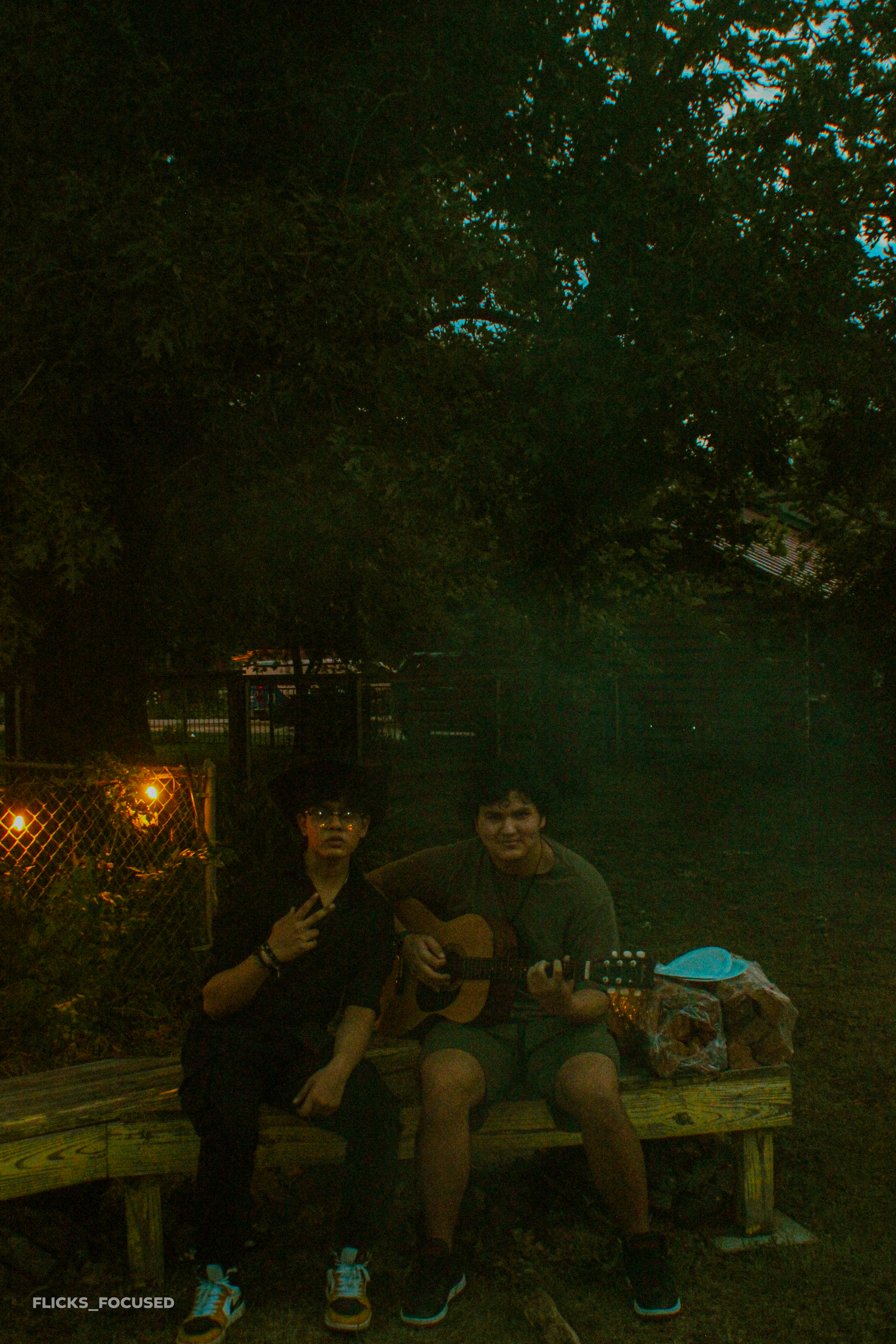 Friends playing music in a warm, artistic setting